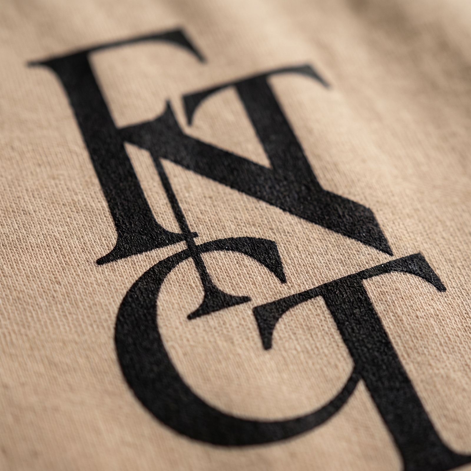 Macro detail of the FNTCT monogram printed on cotton