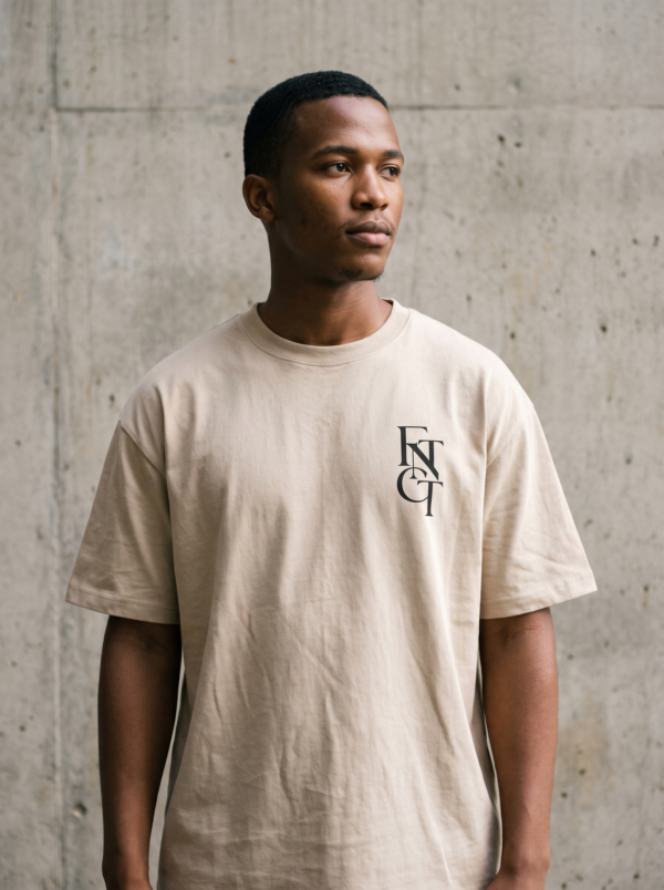 Model wearing the soft cream FNTCT fingerprint tee