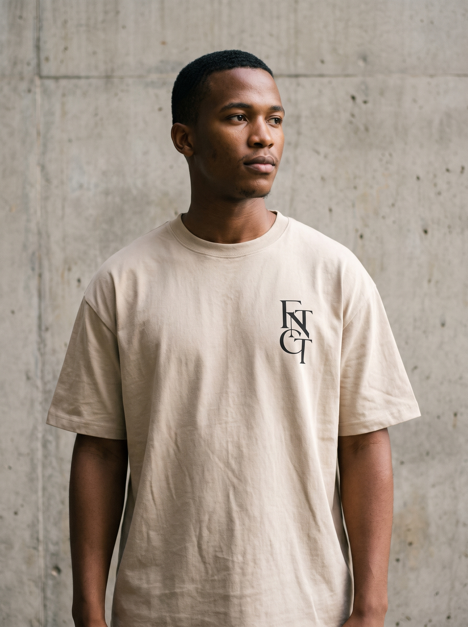 Model wearing the soft cream FNTCT fingerprint tee